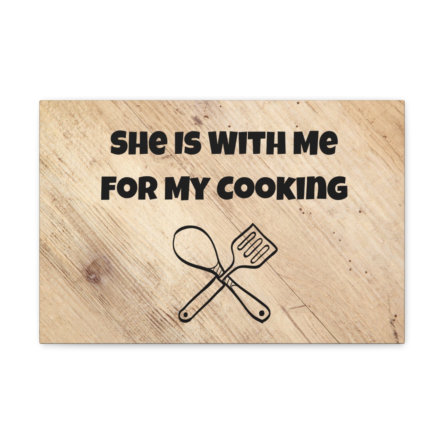 Playful kitchen decor with crossed spoon and spatula
