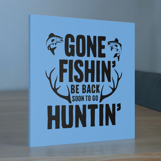 "Gone Fishing, Be Back Soon to Go Huntin' canvas wall art on a living room wall."
