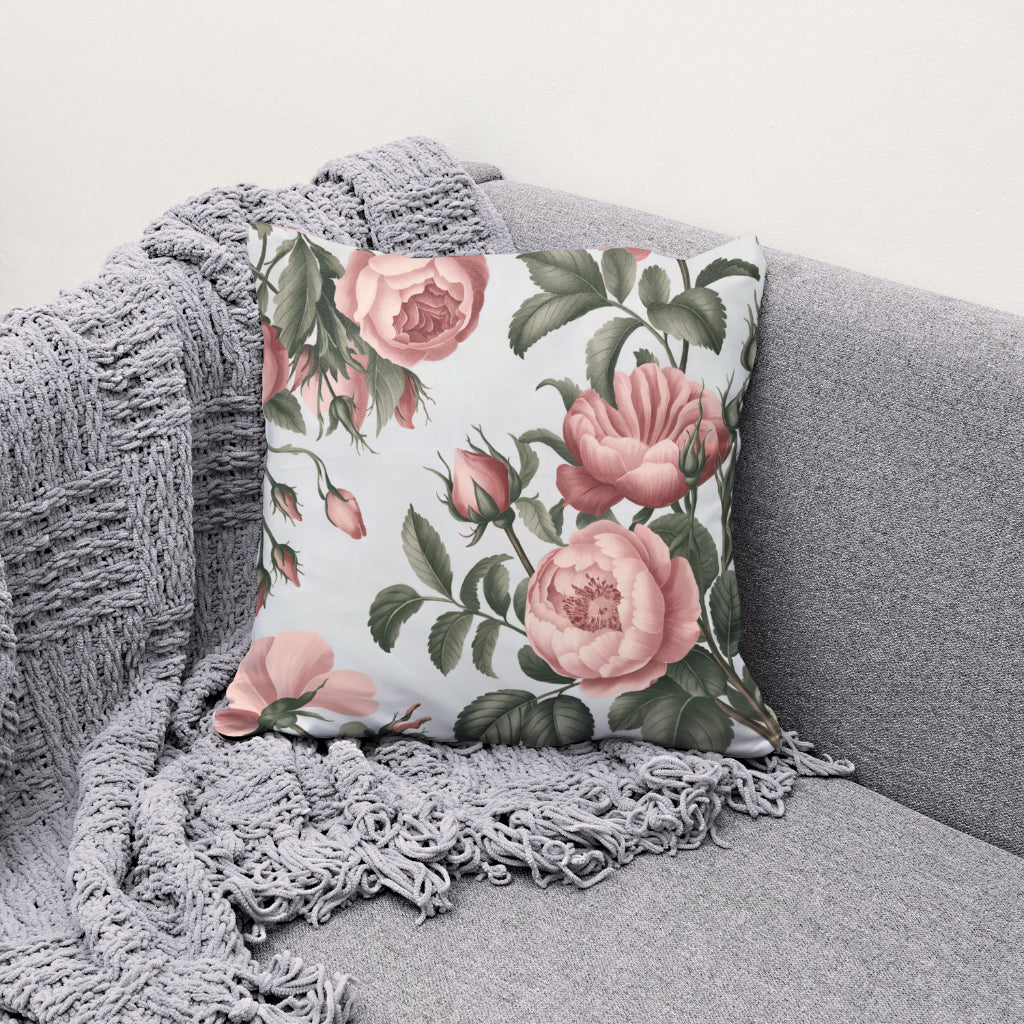 Pink floral pillow with soft pink roses and white background
