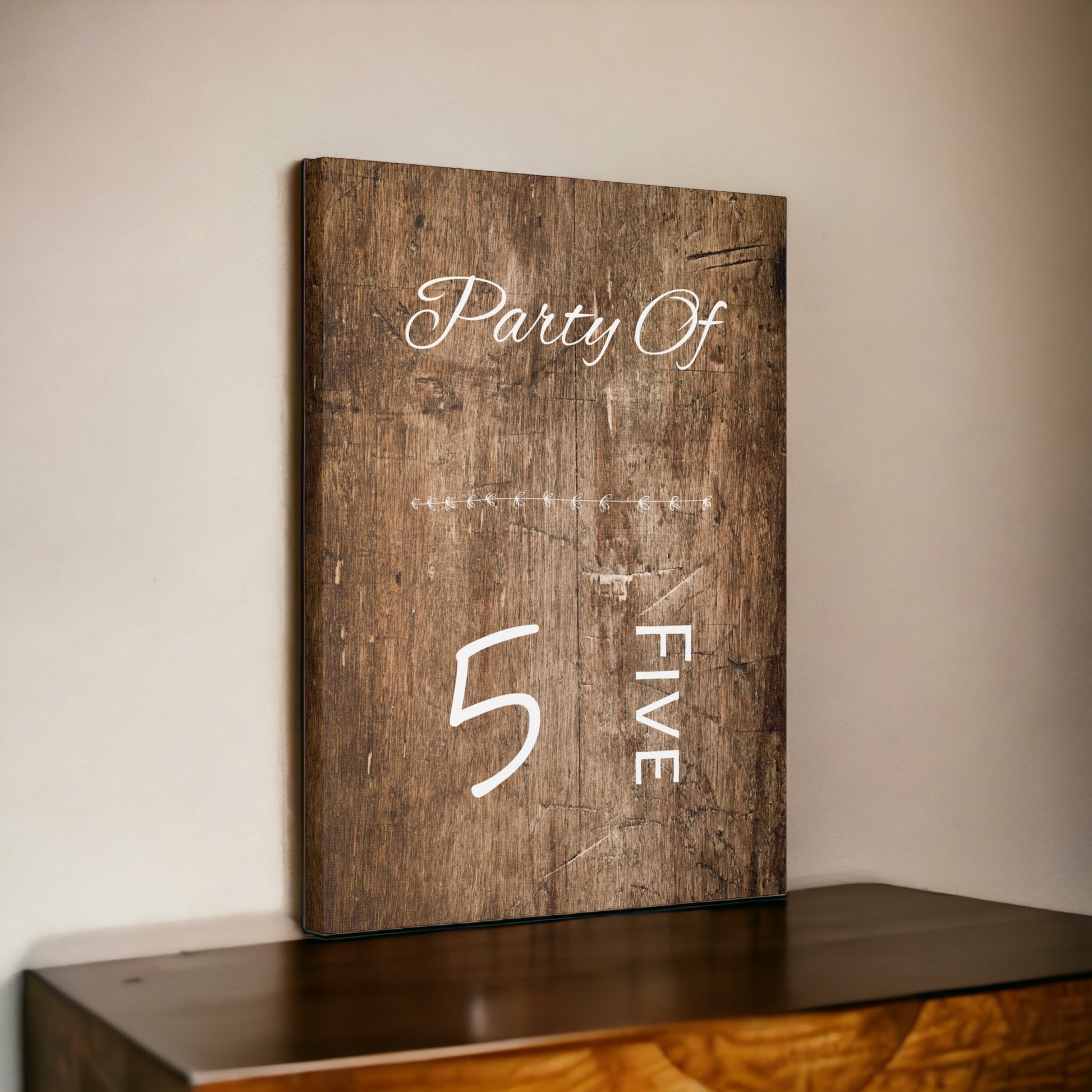 Party of 5 sign with rustic brown background and white cursive text
