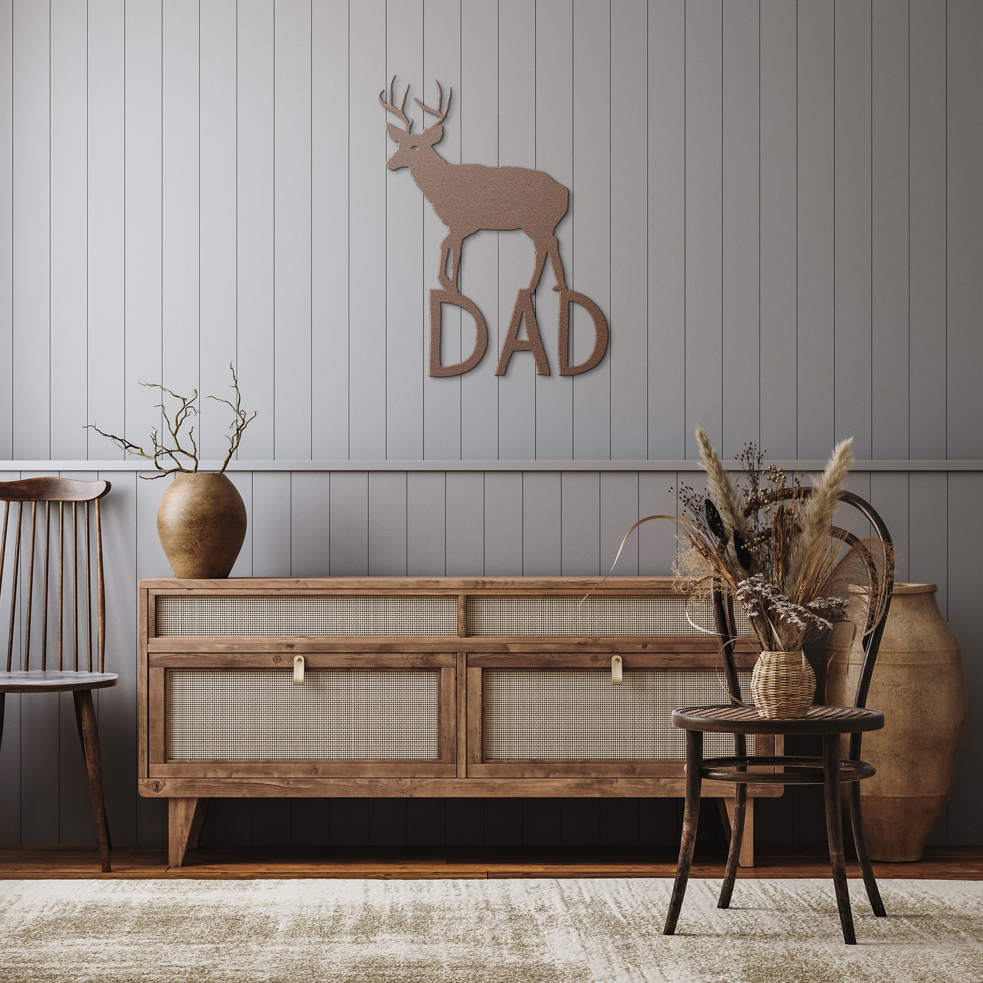 Black metal buck sign against a cabin wall
