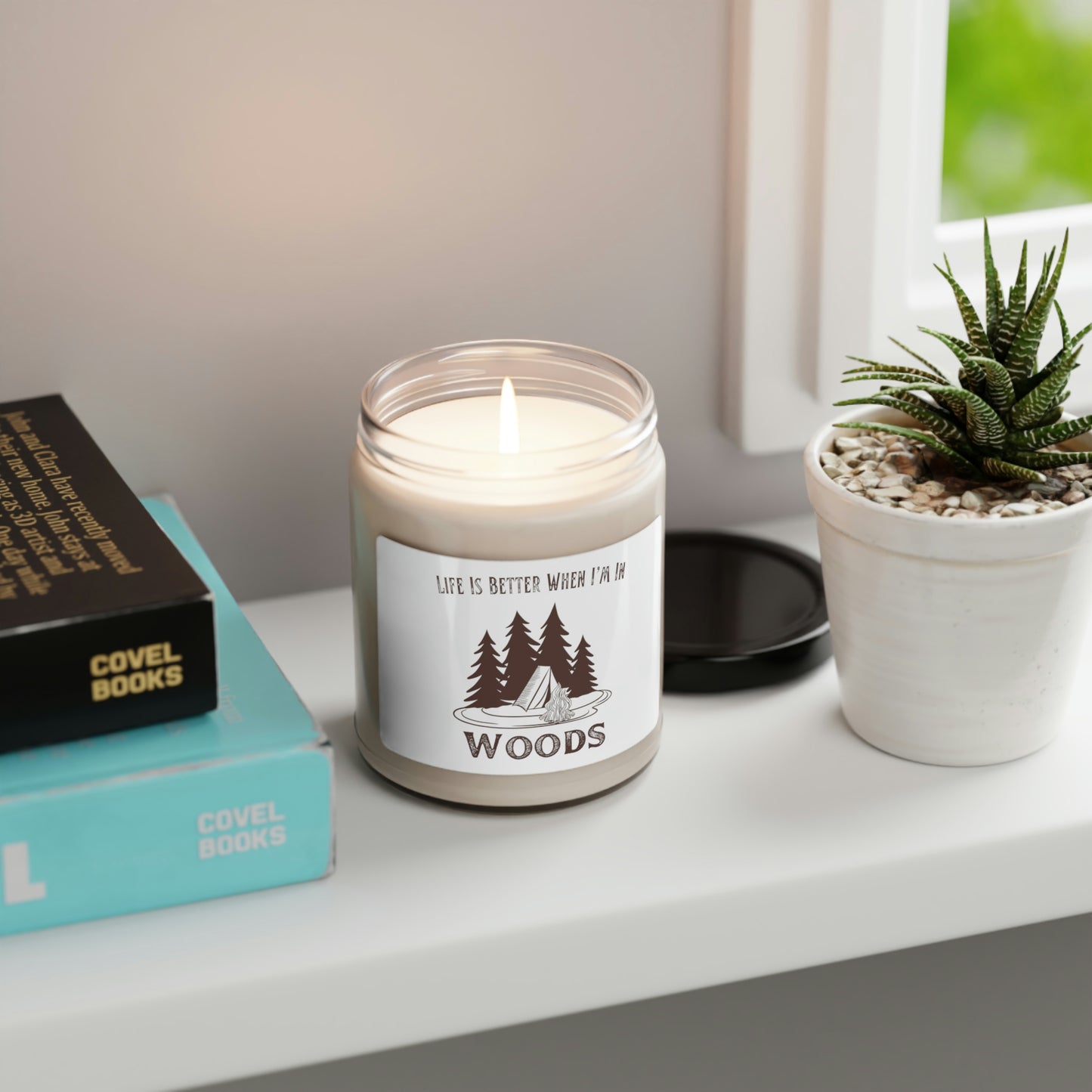 Brown tent and campfire graphic on a scented candle
